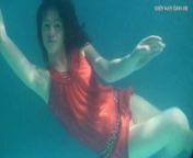Red dressed mermaid Rusalka swimming in the pool from russian nudists naturists