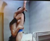 Tall Asian chick holds guy upside down from tall asian