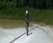Super Hot Blond Girl In Black Latex Catsuit + High Heels And Sunglasses Bathes In The Mud - Mud Bath from lodo