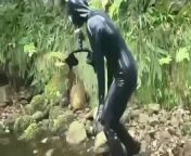 Outdoor walk in the wood and river bath full encased in black latex catsuit and rubber gas mask from asian girls bath in river